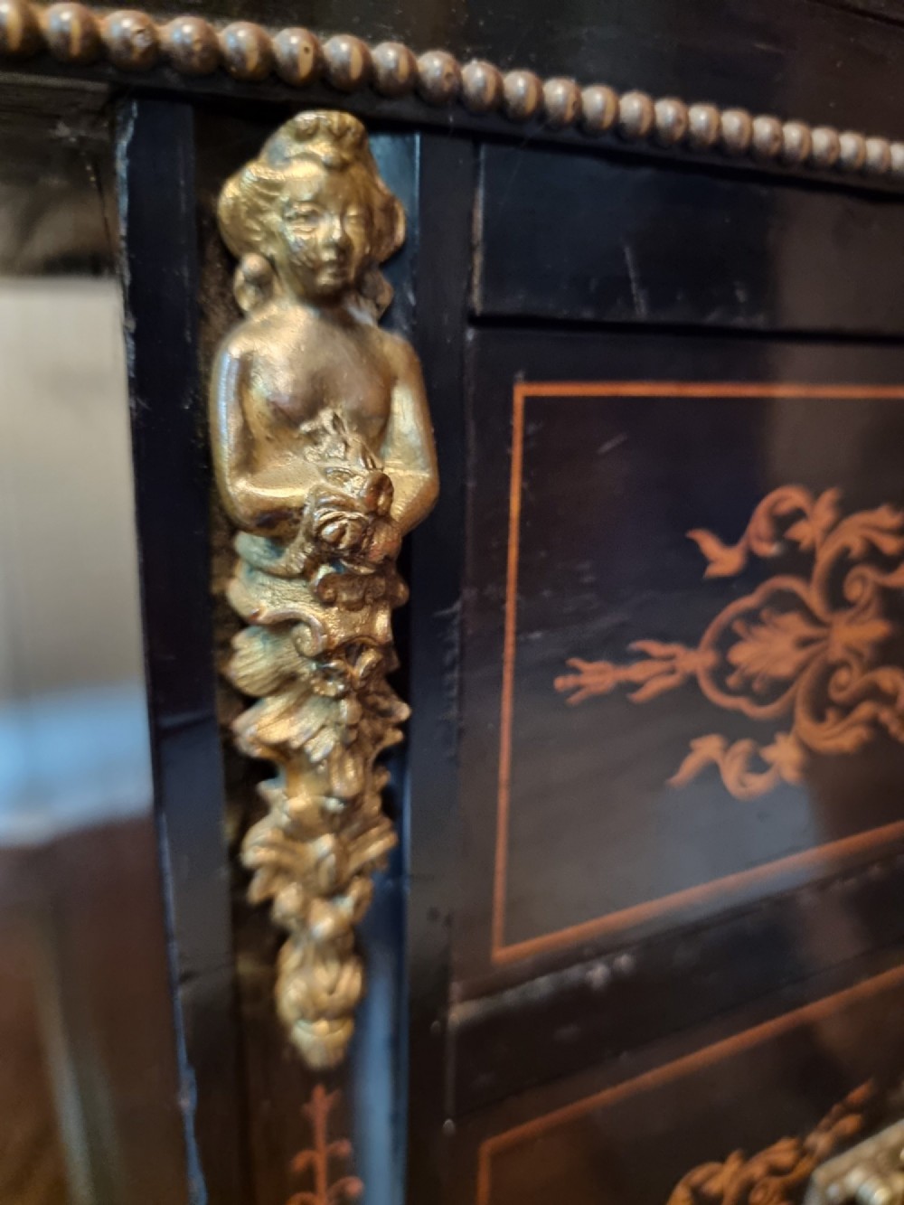 A dark ebonised Victorian pedestal desk featuring detailed floral marquetry inlay, brass handles, ormolu corner mounts, and a leather insert top. View XII