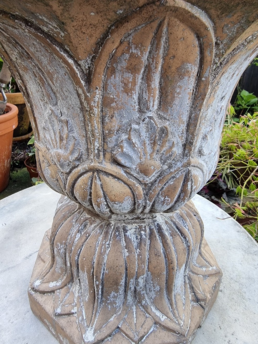 A 19th-century terracotta garden urn featuring carved leaf moulding, an octagonal top rim, and a flared pedestal base with weathered patina. View III