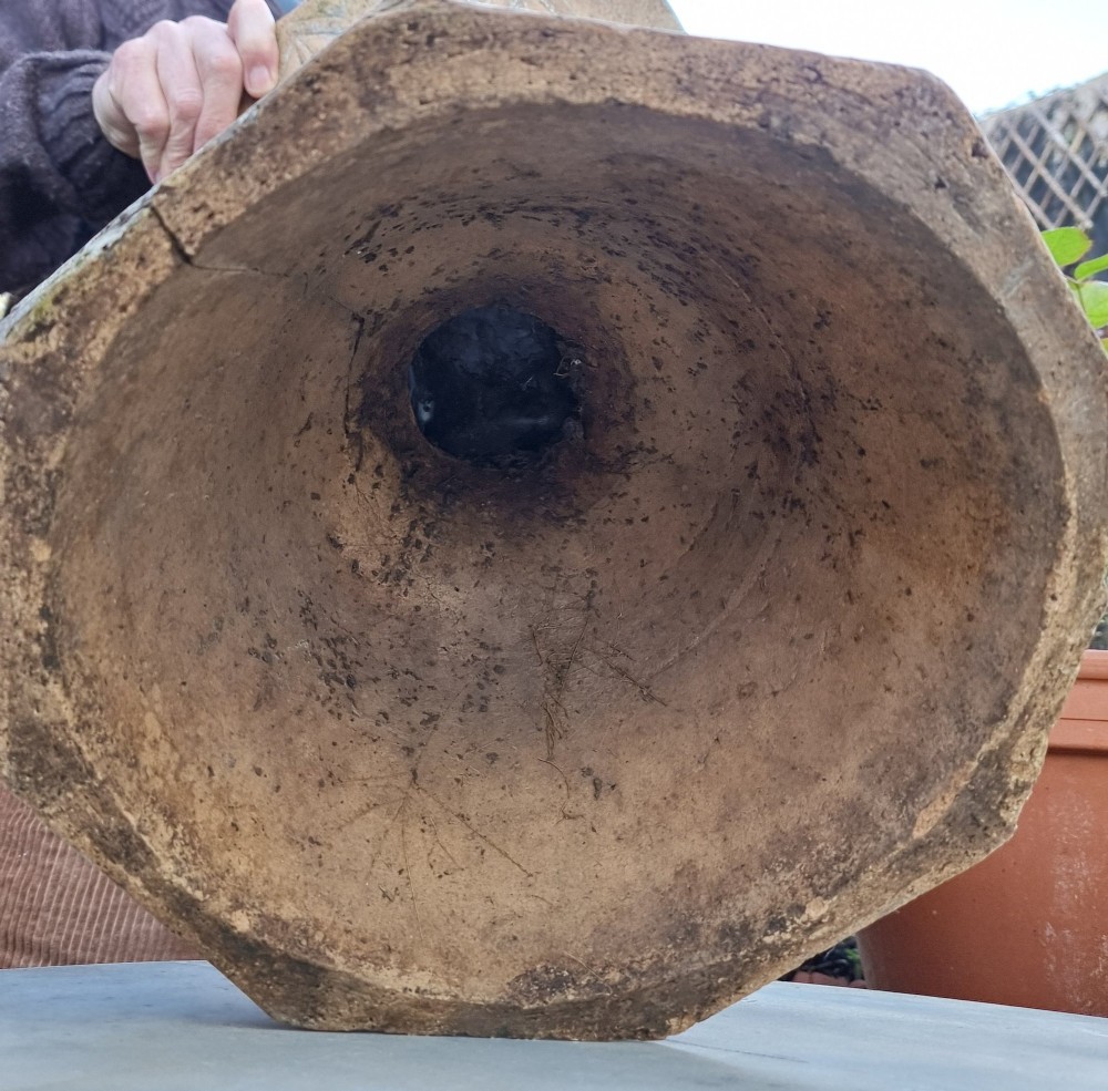 A 19th-century terracotta garden urn featuring carved leaf moulding, an octagonal top rim, and a flared pedestal base with weathered patina. View V