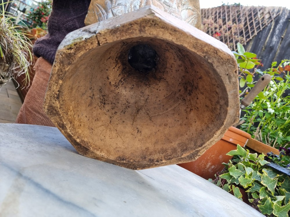A 19th-century terracotta garden urn featuring carved leaf moulding, an octagonal top rim, and a flared pedestal base with weathered patina. View VI