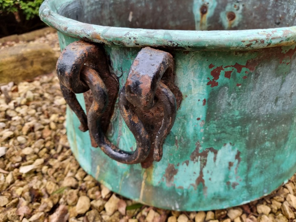 A large circular 19th-century copper vessel with a heavy verdigris green patina and dual wrought-iron drop handles. View IX