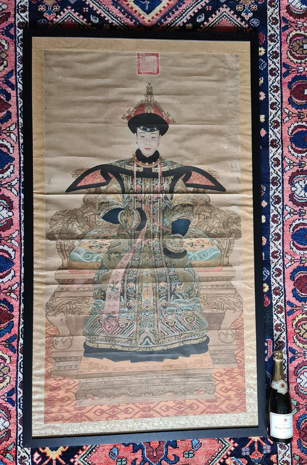 A large pair of framed Chinese ancestral portraits depicting a male and female figure in traditional formal court robes seated on ornate thrones. View II