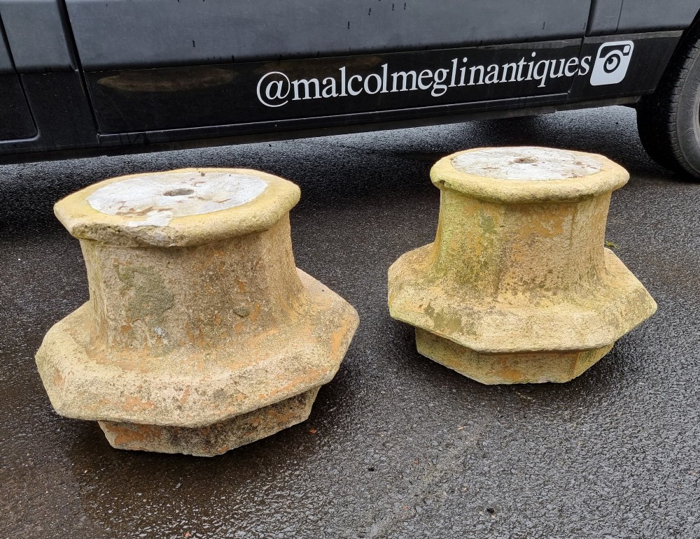 A pair of heavy octagonal composite stone garden plinths featuring moulded borders, central fixing holes, and weathered surface texture. View II