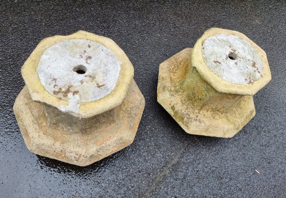 A pair of heavy octagonal composite stone garden plinths featuring moulded borders, central fixing holes, and weathered surface texture. View III
