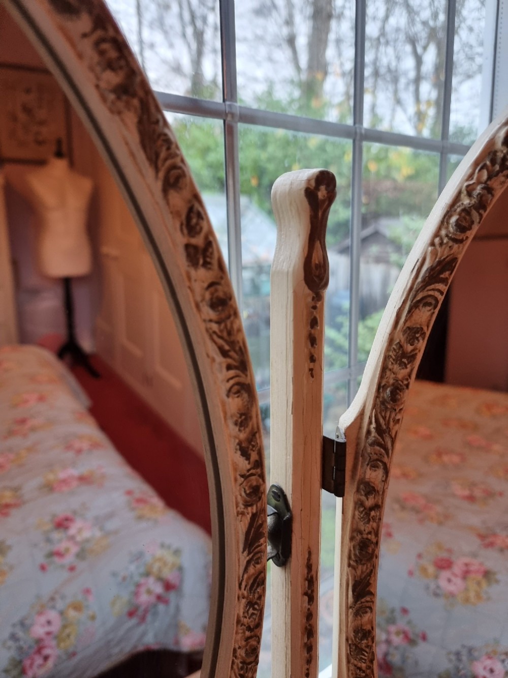 A 1930s cream-painted triple vanity mirror featuring three oval glass panels set in ornate scrollwork frames. View VIII