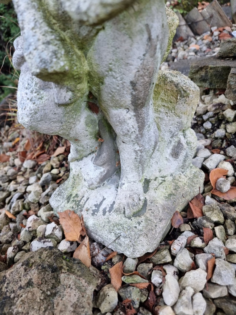 A pair of weathered grey reconstituted stone garden statues depicting classical musical cherubs holding instruments. View VI