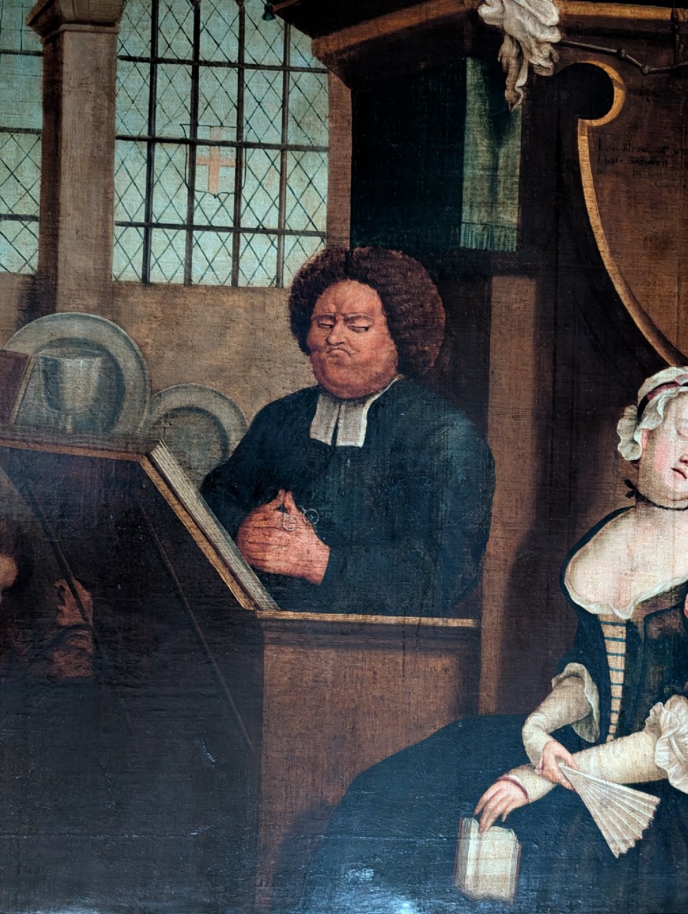An antique framed oil painting depicting a clergyman speaking to a sleeping congregation inside an eighteenth-century church interior. View IV