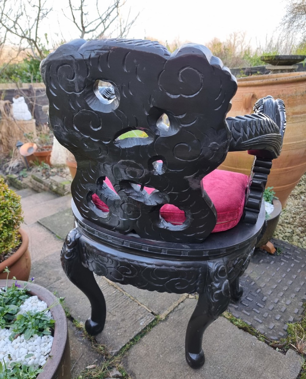 A deeply carved black hardwood armchair featuring dragon head armrests, a dragon backrest, and a red velvet seat cushion. View XI