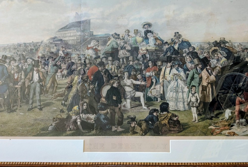 A panoramic 19th-century framed print depicting a densely populated scene at the Epsom Derby within a cream mount and gilt wooden frame. View V