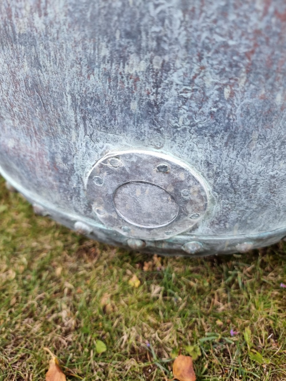 A large cylindrical French copper garden pot featuring a flared rolled rim, hand-riveted base seam, and a naturally weathered verdigris patina. View IX