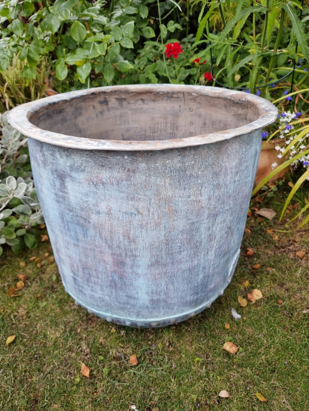 A large cylindrical French copper garden pot featuring a flared rolled rim, hand-riveted base seam, and a naturally weathered verdigris patina. View X