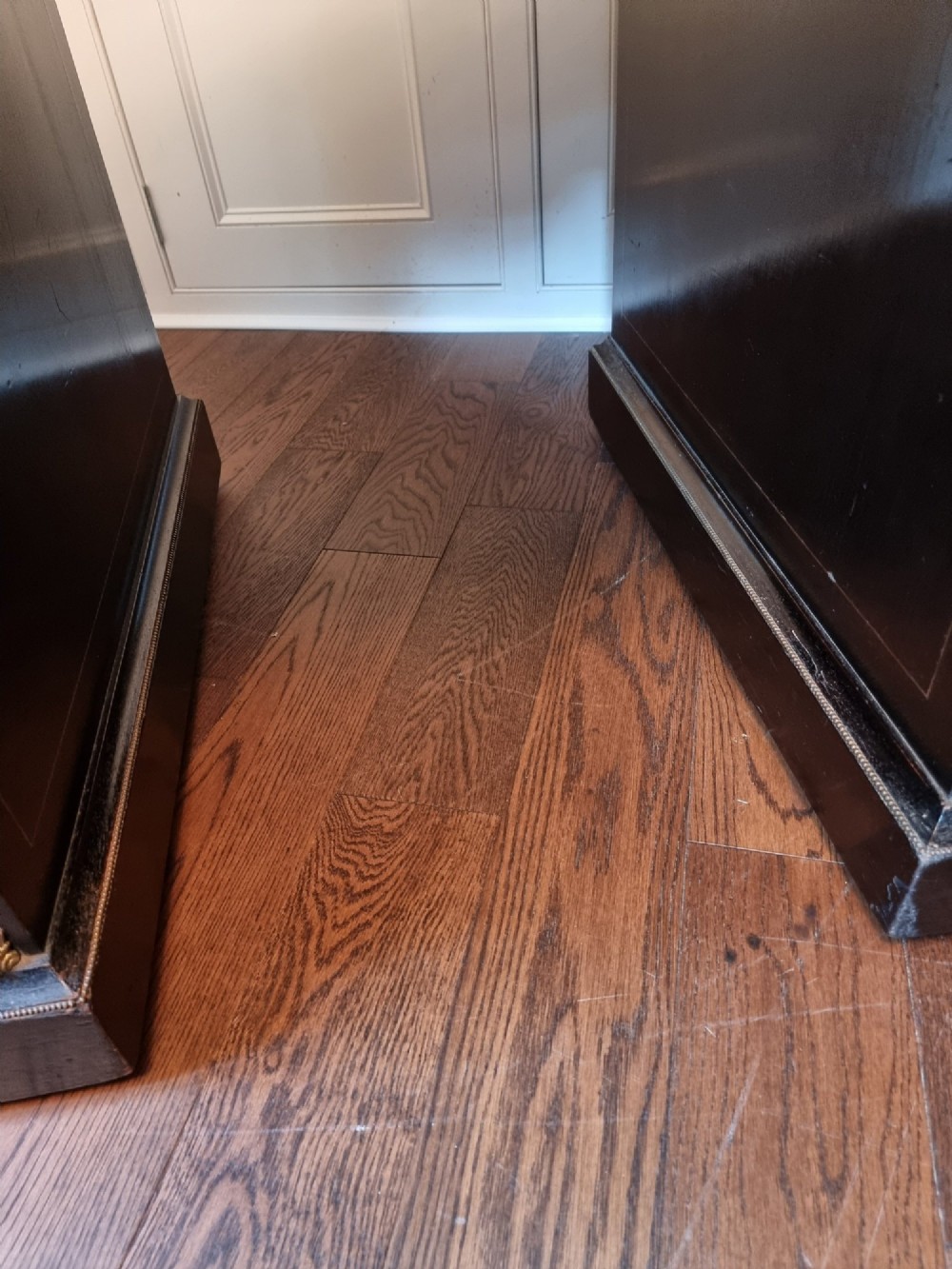 A dark Victorian pedestal desk with marquetry inlay, brass handles, ornate corner mounts, and a leather inset writing surface. View VII