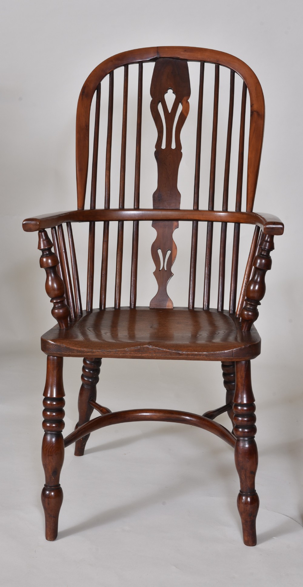 A pair of 19th-century yew wood Windsor armchairs with hoop backs, pierced splats, turned legs, and crinoline stretchers. View II