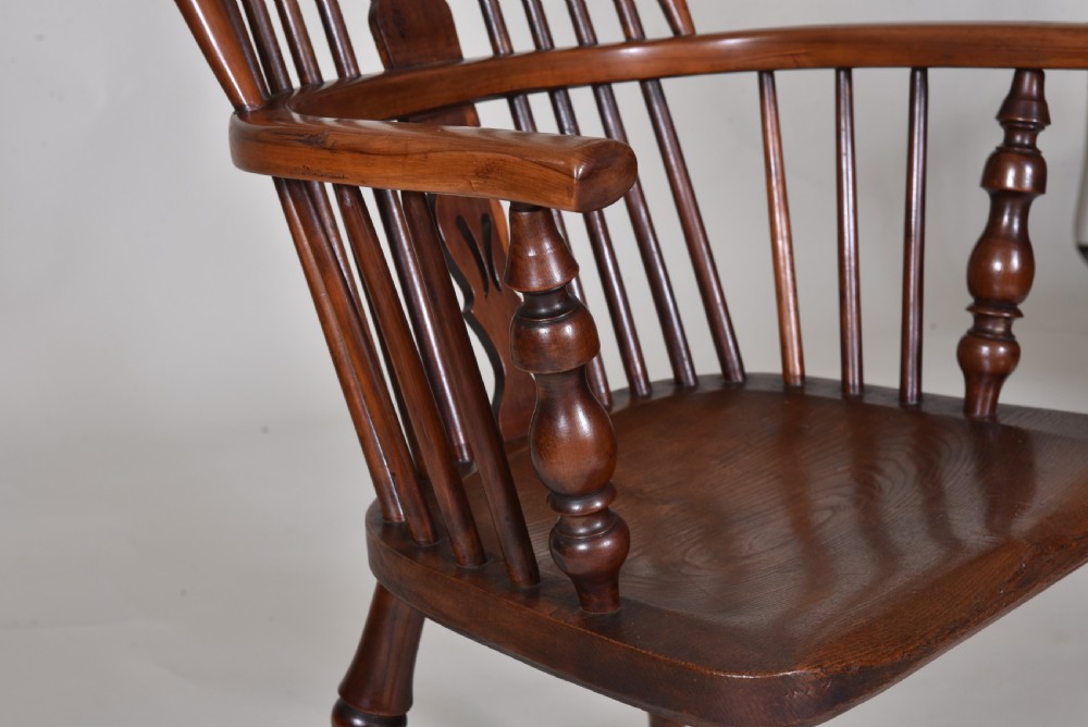 A pair of 19th-century yew wood Windsor armchairs with hoop backs, pierced splats, turned legs, and crinoline stretchers. View V