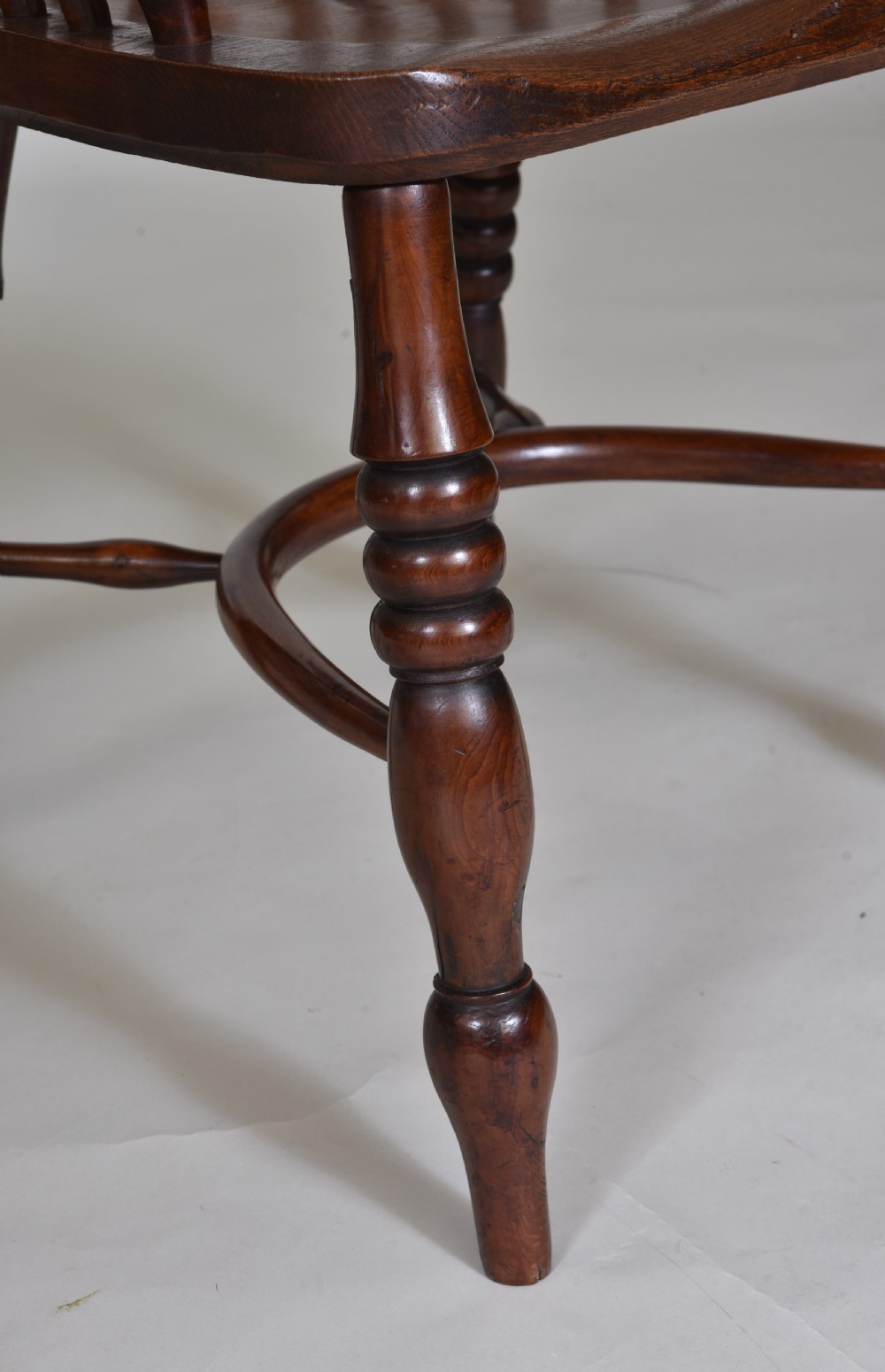 A pair of 19th-century yew wood Windsor armchairs with hoop backs, pierced splats, turned legs, and crinoline stretchers. View VI