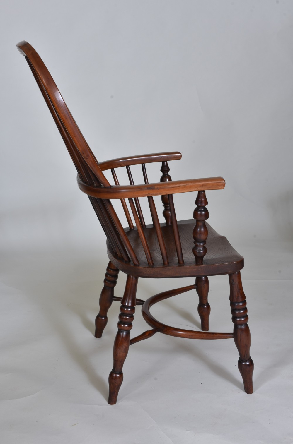 A pair of 19th-century yew wood Windsor armchairs with hoop backs, pierced splats, turned legs, and crinoline stretchers. View VII