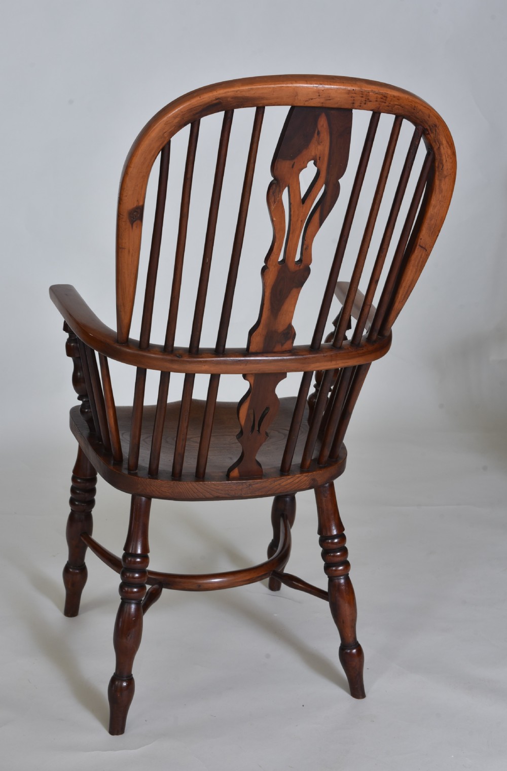 A pair of 19th-century yew wood Windsor armchairs with hoop backs, pierced splats, turned legs, and crinoline stretchers. View VIII