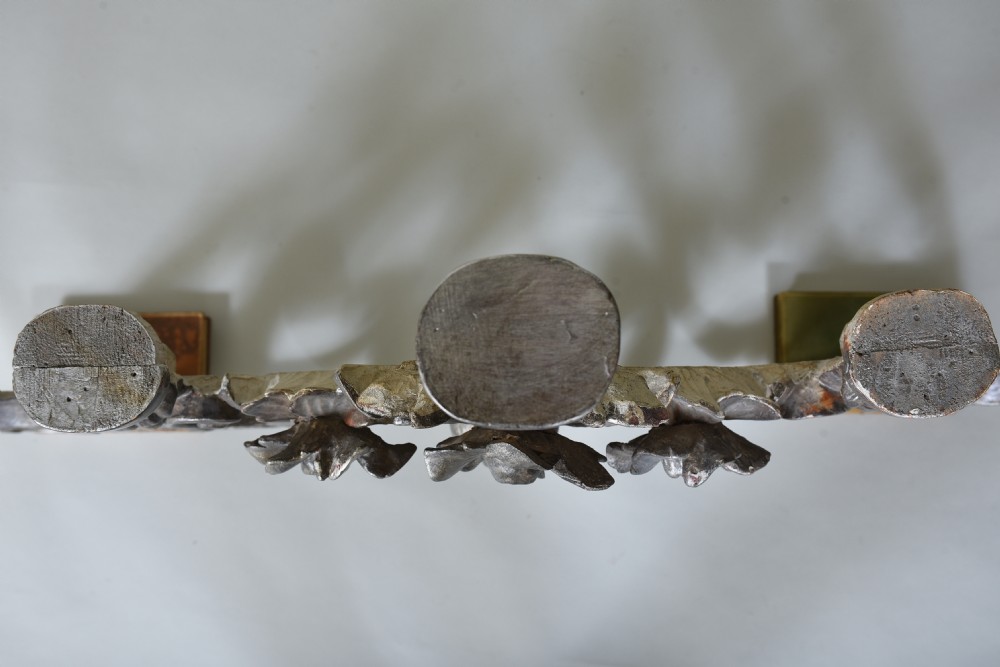 An 18th-century Italian carved wooden pediment finished in aged silver leaf featuring floral motifs, acanthus scrollwork, and raised pedestals. View VIII
