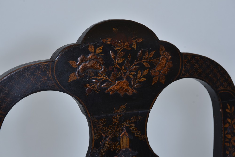 A pair of black lacquered Queen Anne style side chairs featuring vasiform splats, hand-painted gold Chinoiserie patterns, cabriole front legs, and yellow upholstered drop-in seats. View V