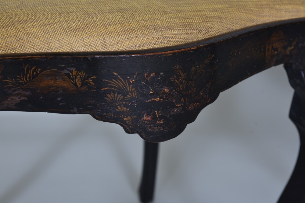 A pair of black lacquered Queen Anne style side chairs featuring vasiform splats, hand-painted gold Chinoiserie patterns, cabriole front legs, and yellow upholstered drop-in seats. View VII