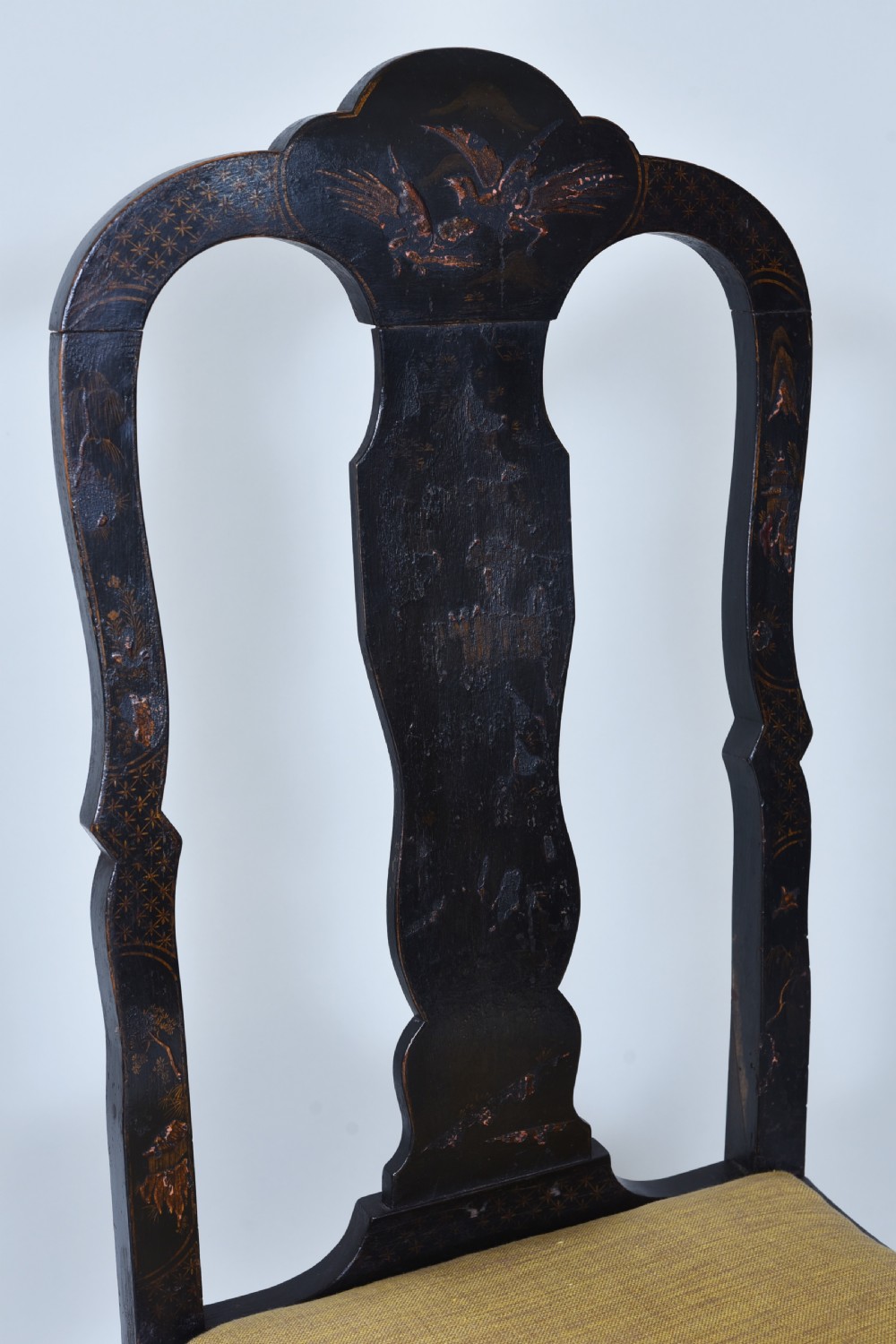 A pair of black lacquered Queen Anne style side chairs featuring vasiform splats, hand-painted gold Chinoiserie patterns, cabriole front legs, and yellow upholstered drop-in seats. View XIII