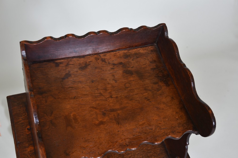 An 18th-century dark oak side table featuring curved cabriole legs, a scalloped apron, and a raised two-tier scalloped gallery shelf. View V