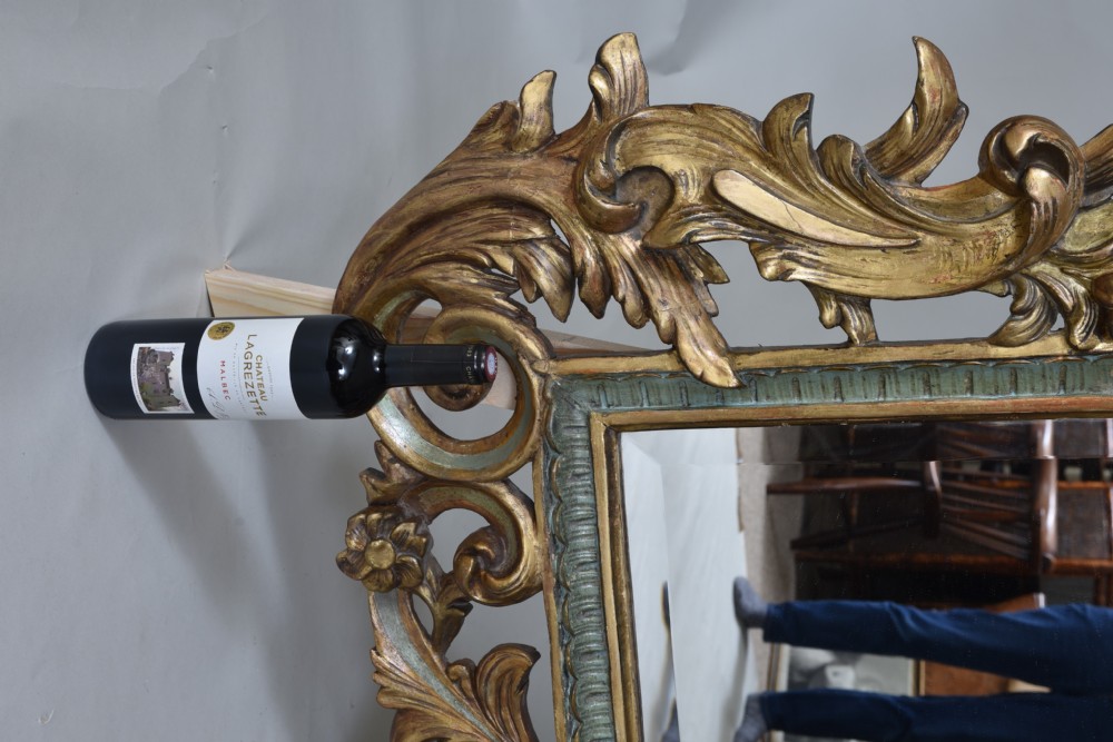 An ornate rectangular wall mirror featuring an elaborate carved giltwood frame decorated with shell motifs, acanthus leaf flourishes, and subtle teal painted accents. View III