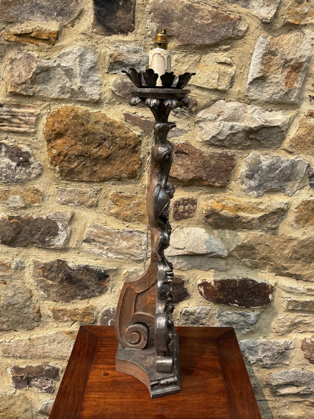 A tall, hand-carved wooden lamp base featuring Baroque scrollwork and an antiqued silver leaf finish. View VIII