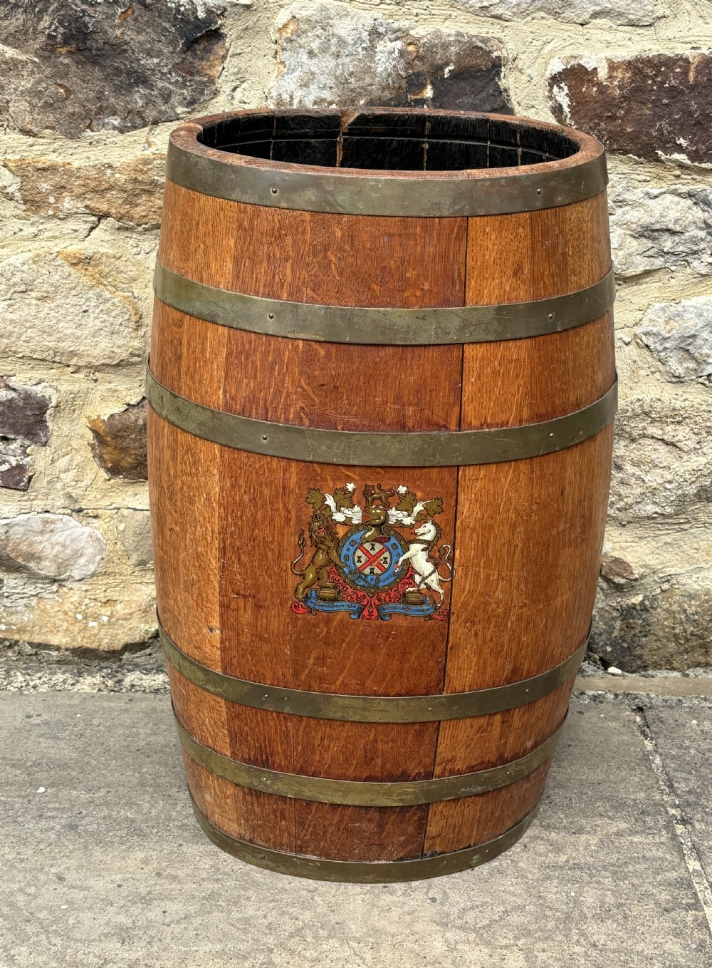 A 19th-century coopered oak barrel stick stand featuring brass hoops and a hand-painted crest on the front. View II