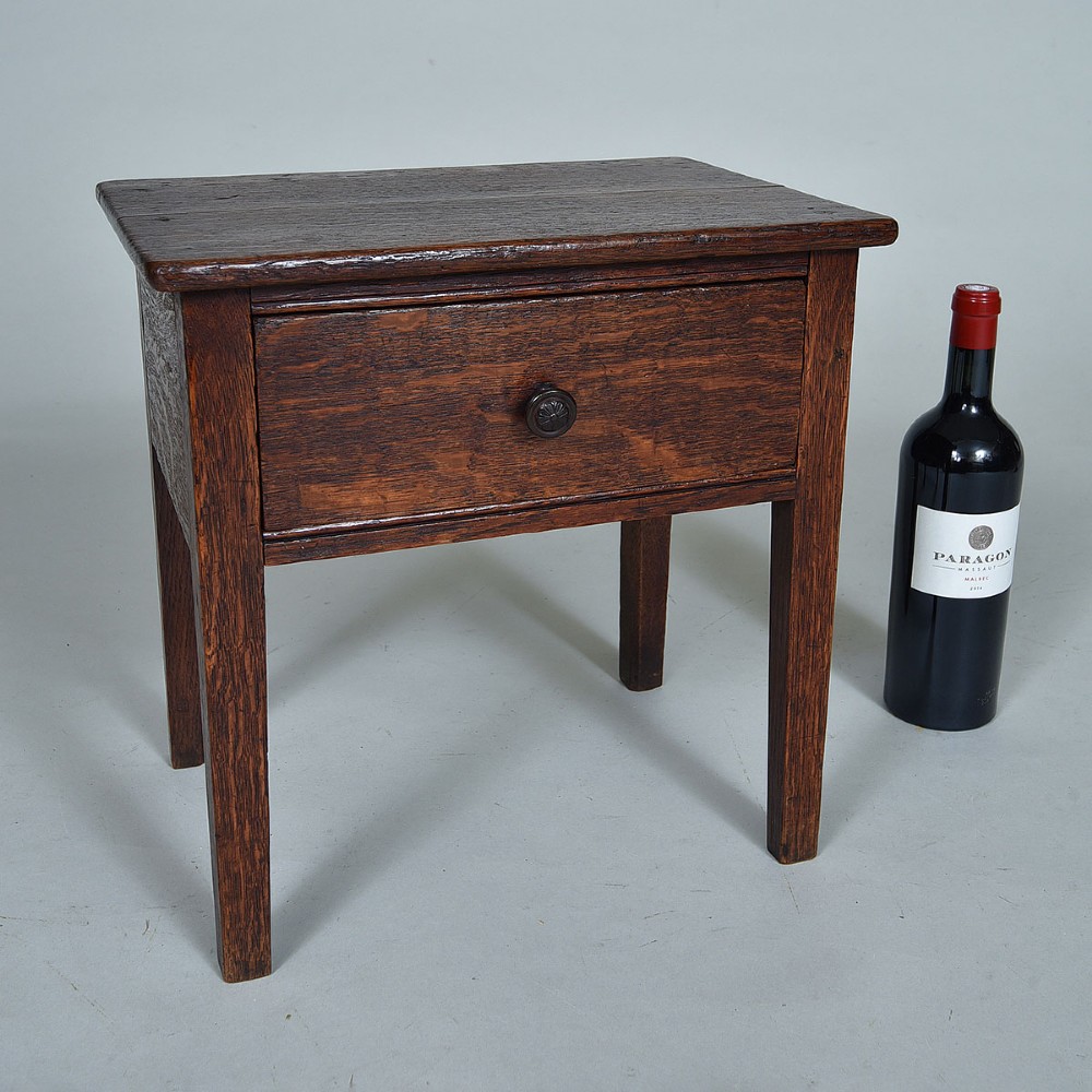 An early 19th-century dark oak side table featuring a single drawer with a turned wood knob and four straight square legs. View II
