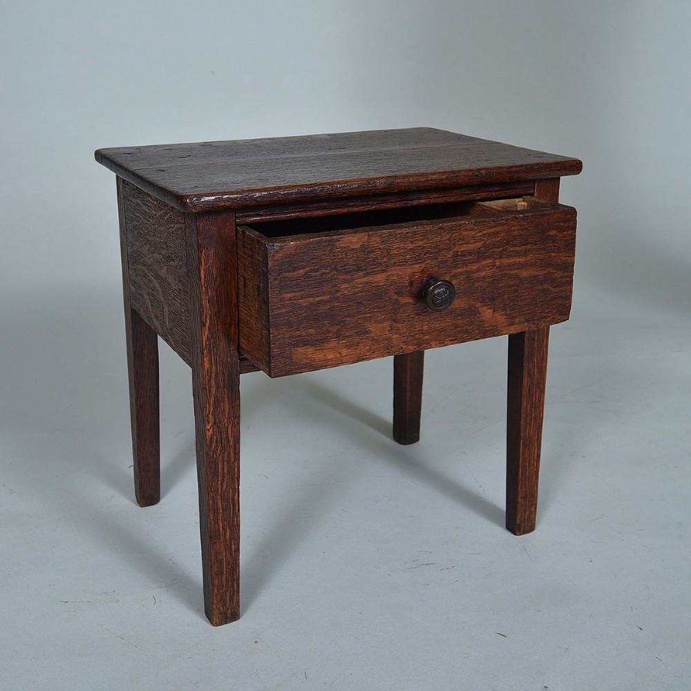 An early 19th-century dark oak side table featuring a single drawer with a turned wood knob and four straight square legs. View III