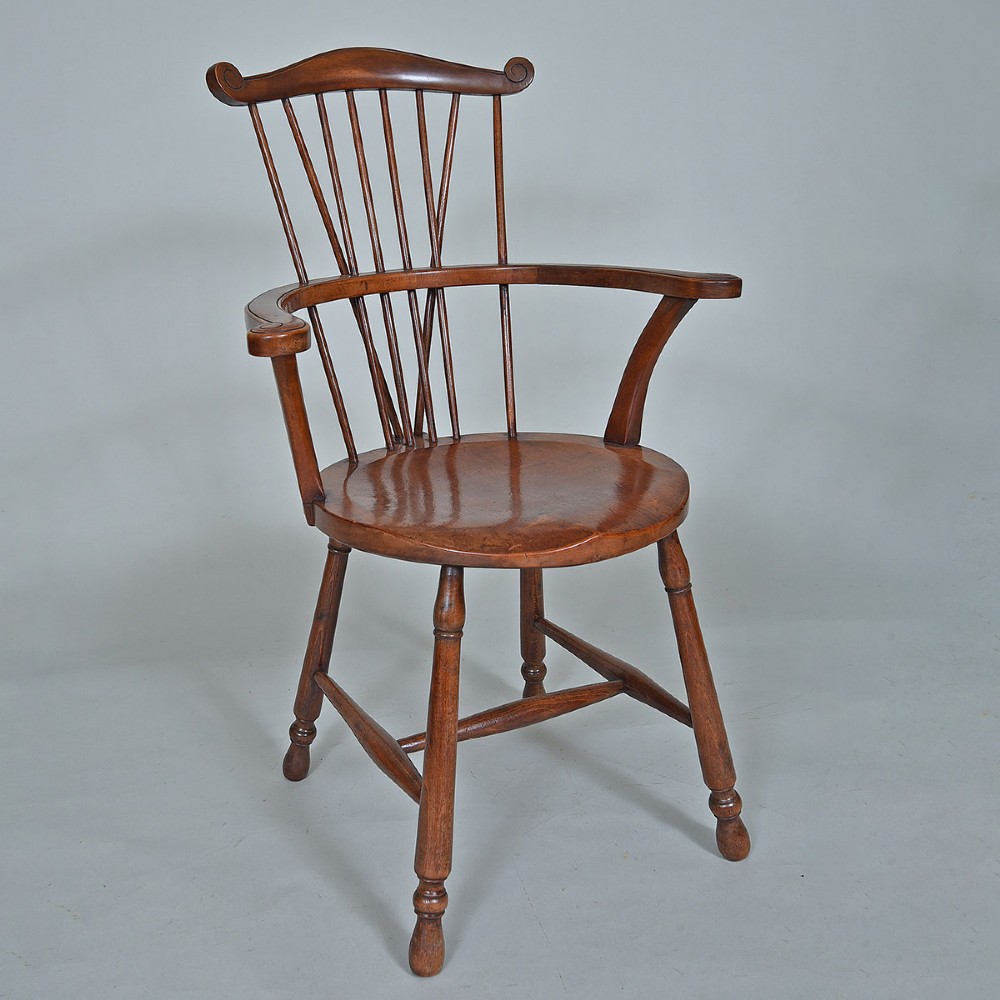 A late 19th-century wooden Windsor armchair featuring vertical spindles, scrolled ears, a contoured saddle seat, and turned legs. View II