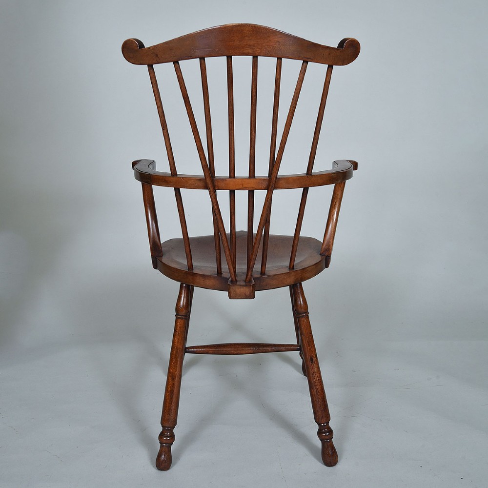 A late 19th-century wooden Windsor armchair featuring vertical spindles, scrolled ears, a contoured saddle seat, and turned legs. View III