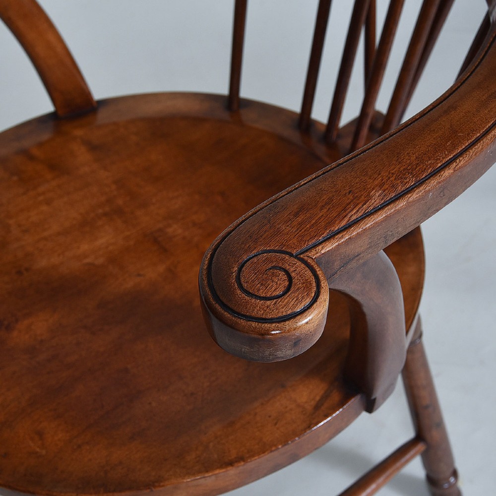 A late 19th-century wooden Windsor armchair featuring vertical spindles, scrolled ears, a contoured saddle seat, and turned legs. View V