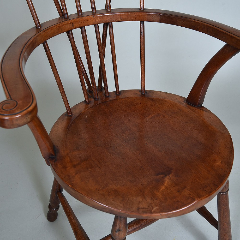A late 19th-century wooden Windsor armchair featuring vertical spindles, scrolled ears, a contoured saddle seat, and turned legs. View VI
