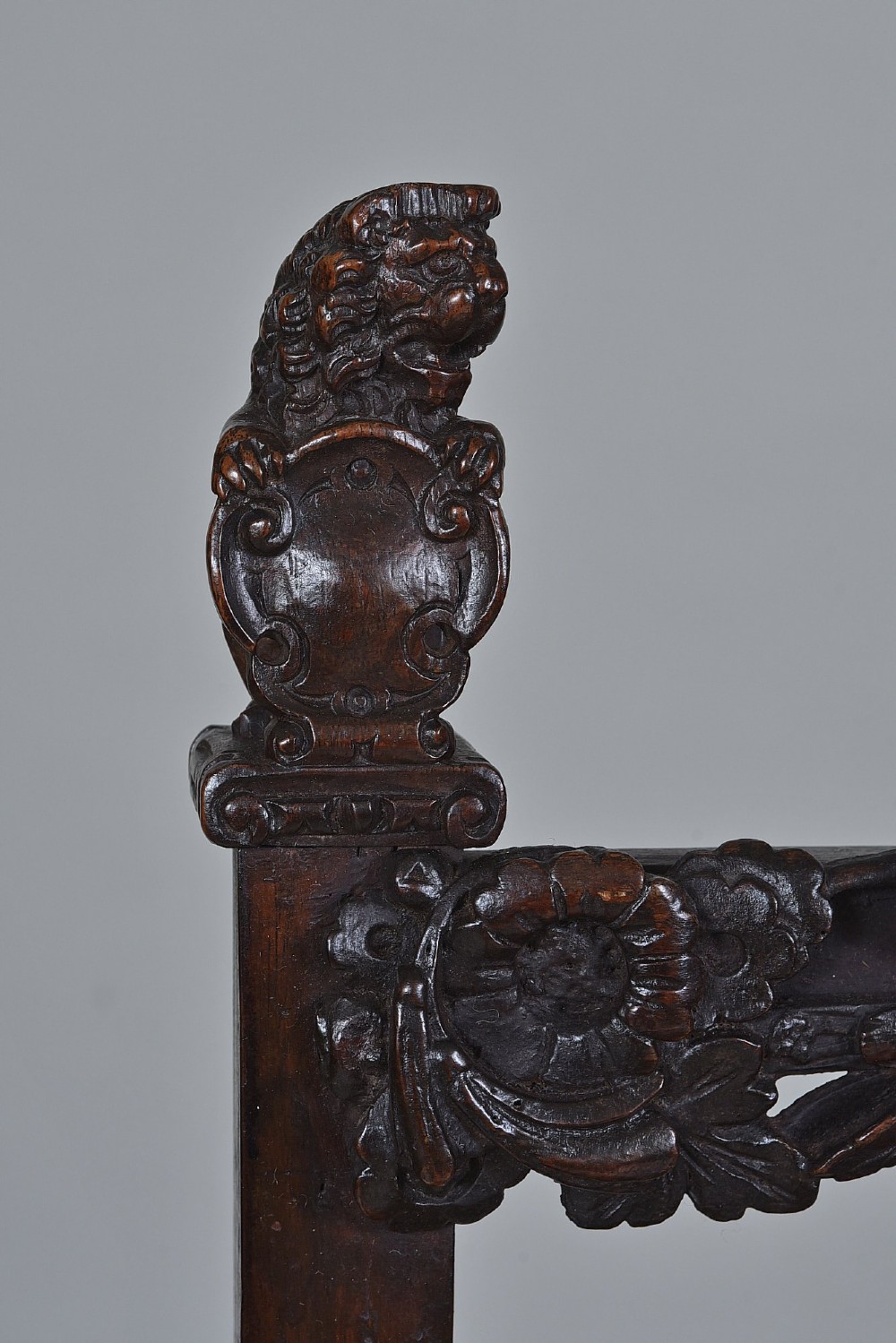 An 18th-century Italian dark walnut armchair featuring intricate openwork foliage carving across the back rails and front stretcher, turned supports, and a patterned woven seat. View IV