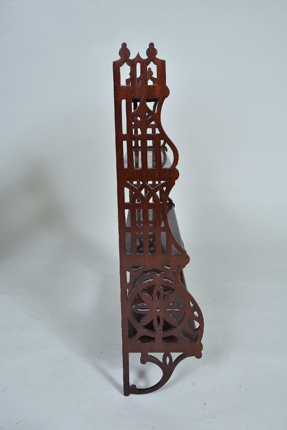 A four-tier mahogany wall shelf featuring open pierced fretwork sides with Gothic-style tracery and brass mounting brackets. View II