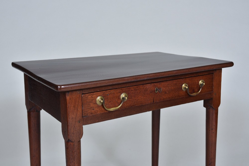A dark Georgian mahogany side table with a single frieze drawer, brass swan-neck handles, and slender legs ending in pad feet. View II