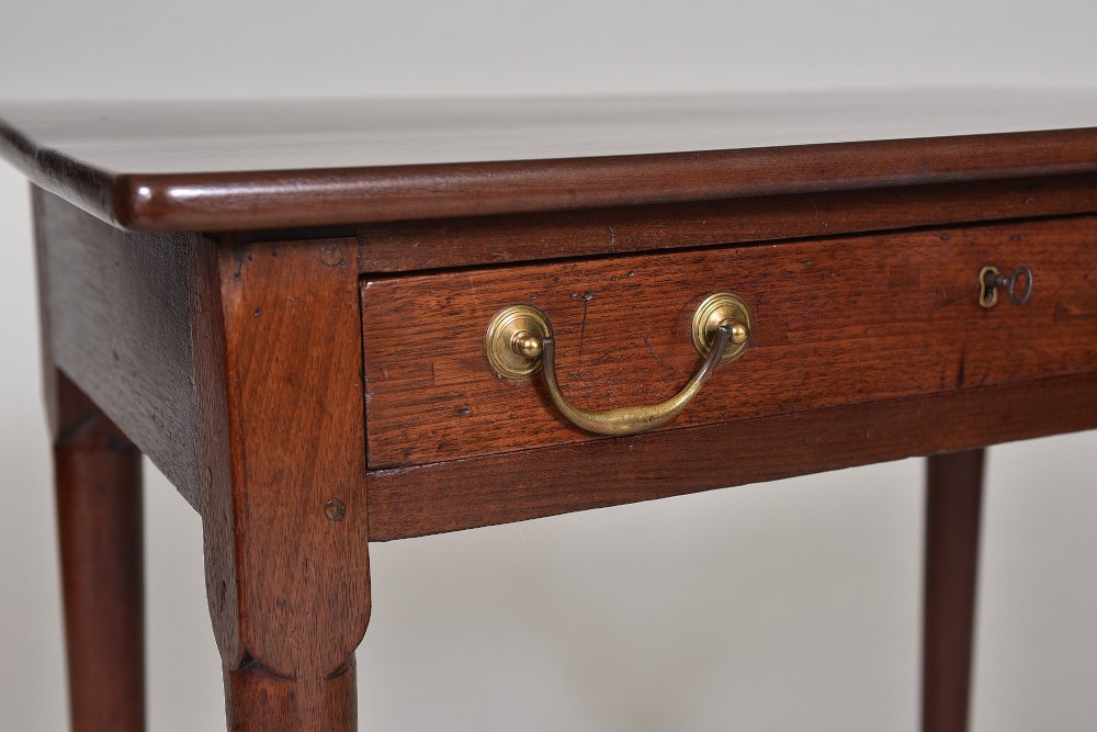 A dark Georgian mahogany side table with a single frieze drawer, brass swan-neck handles, and slender legs ending in pad feet. View III