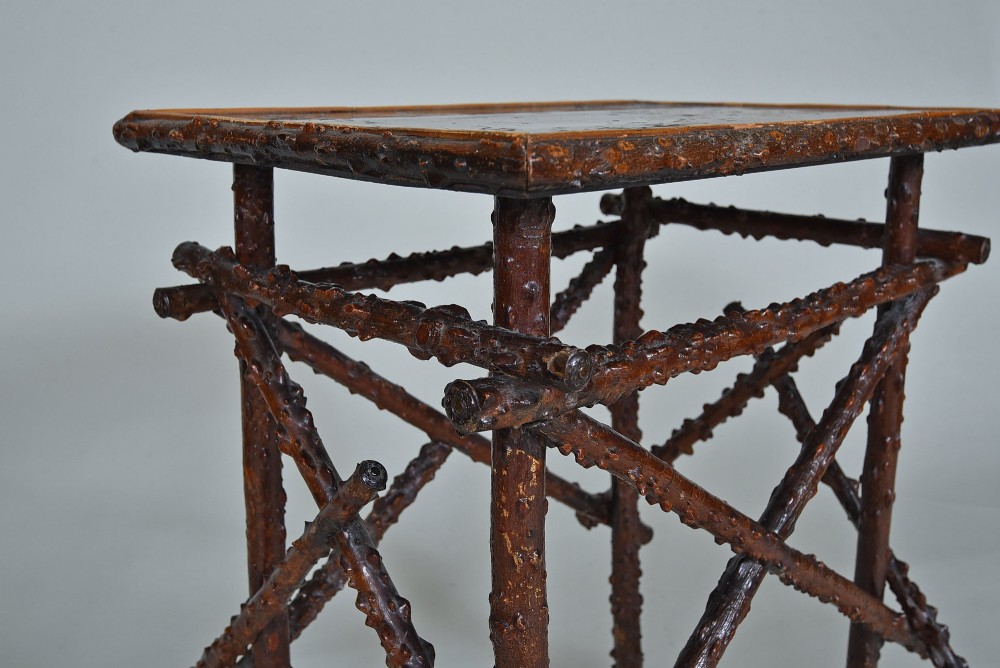 A small rectangular side table constructed from dark brown natural twigs and branches with a smooth lacquered top surface. View III