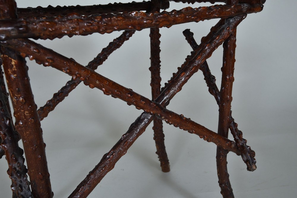 A small rectangular side table constructed from dark brown natural twigs and branches with a smooth lacquered top surface. View VI