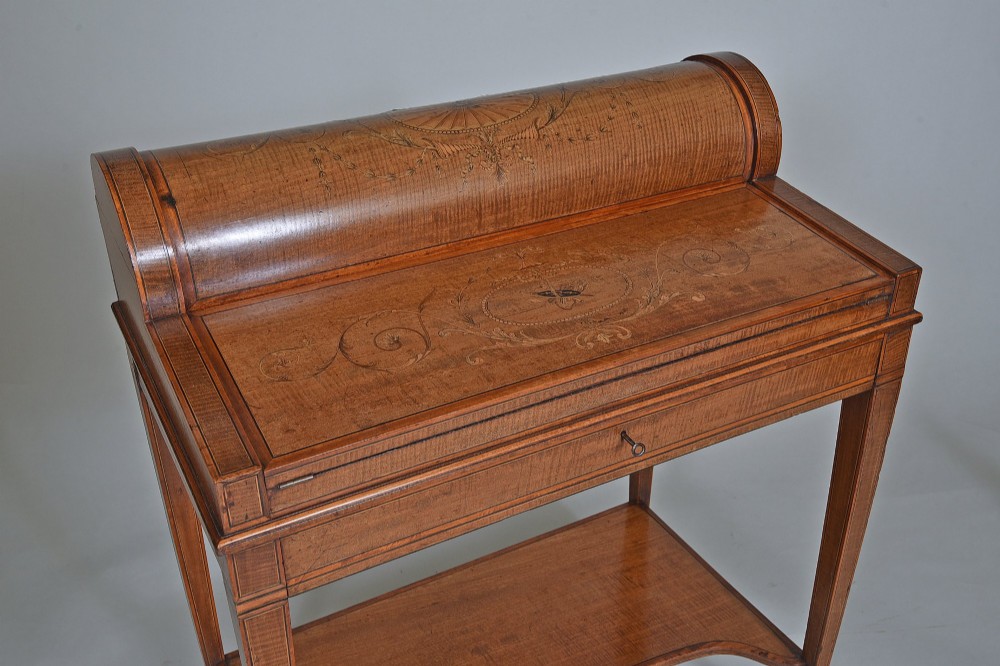 A 19th-century satinwood cylinder bureau featuring an inlaid curved roll-top hood, frieze drawer, square tapered legs, and a shaped lower shelf. View II