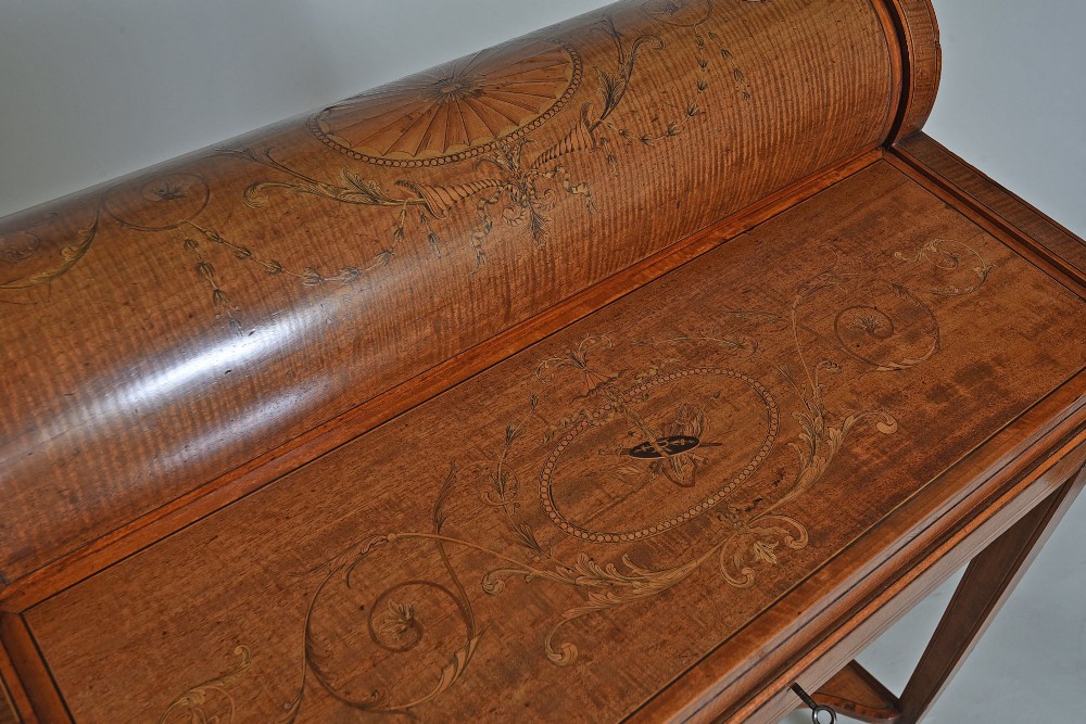 A 19th-century satinwood cylinder bureau featuring an inlaid curved roll-top hood, frieze drawer, square tapered legs, and a shaped lower shelf. View III