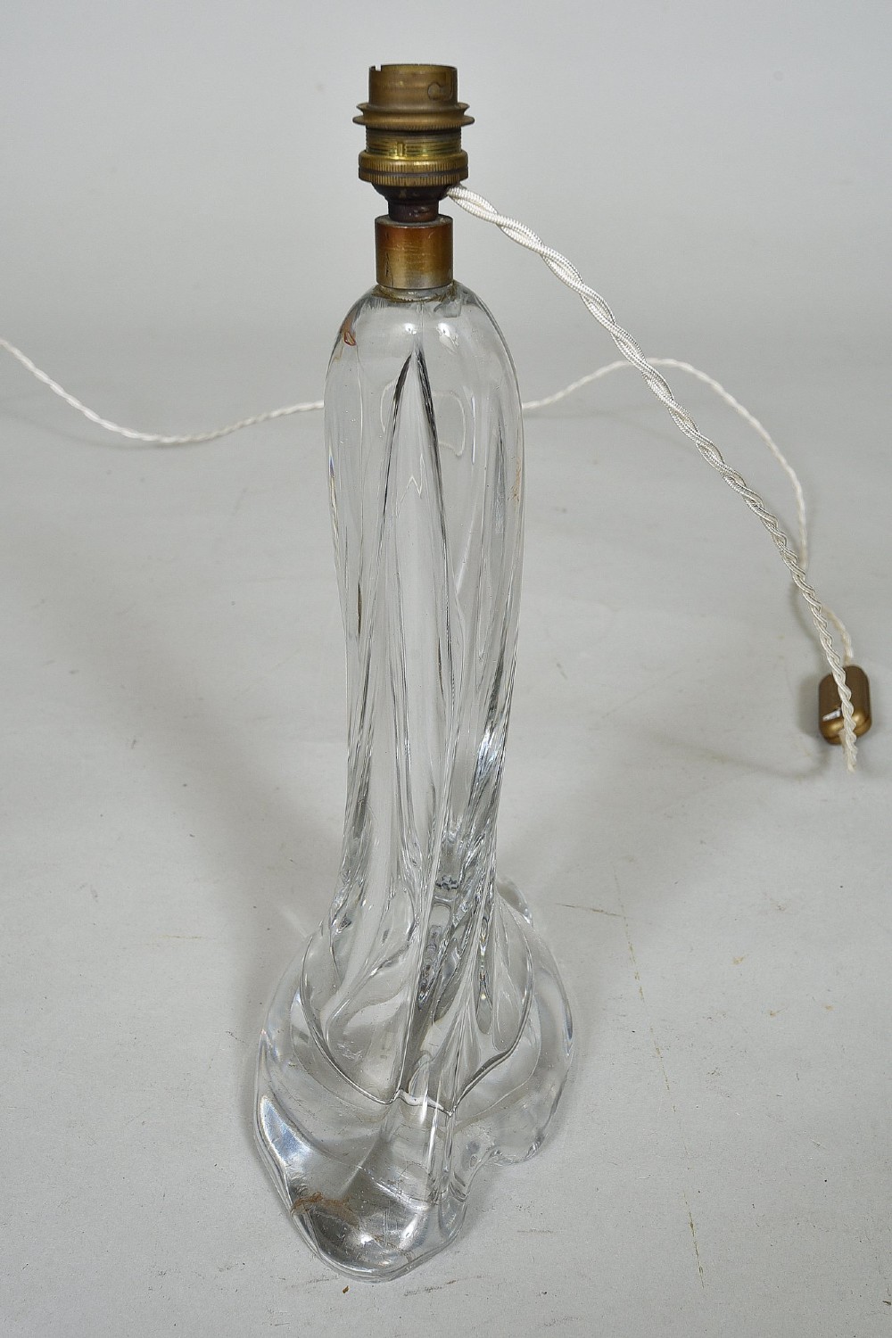 A clear mid-century crystal table lamp base featuring a flared organic form with twisted ribbing and a brass light fitting. View III