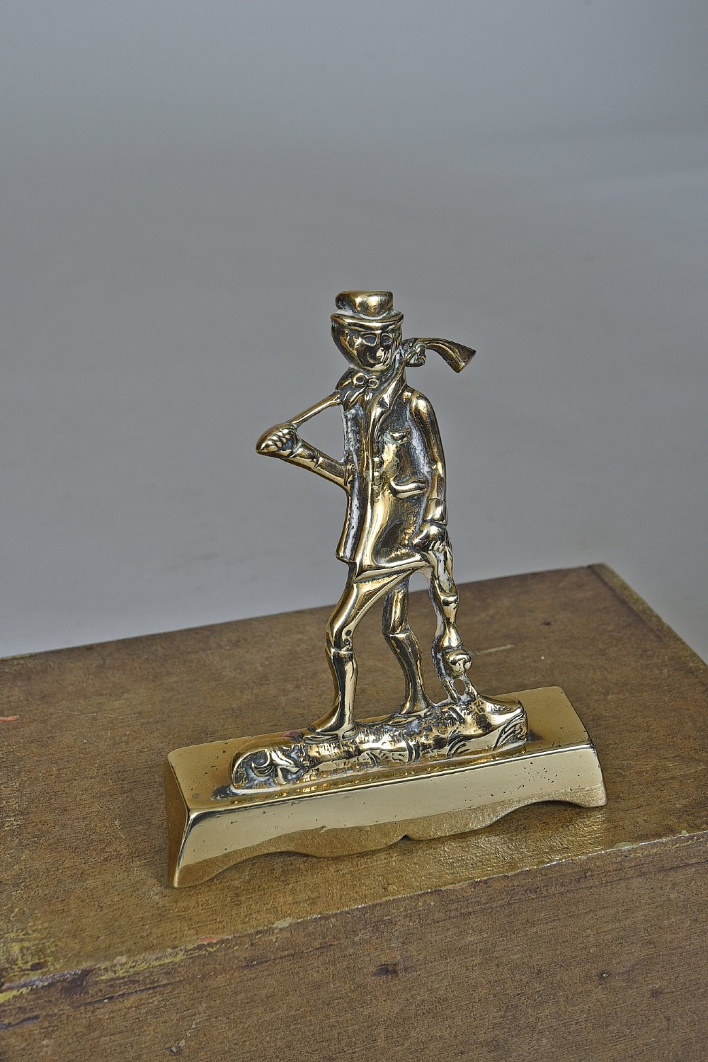 A pair of Victorian cast brass chimney ornaments depicting standing figures with rifles on rectangular plinths. View II
