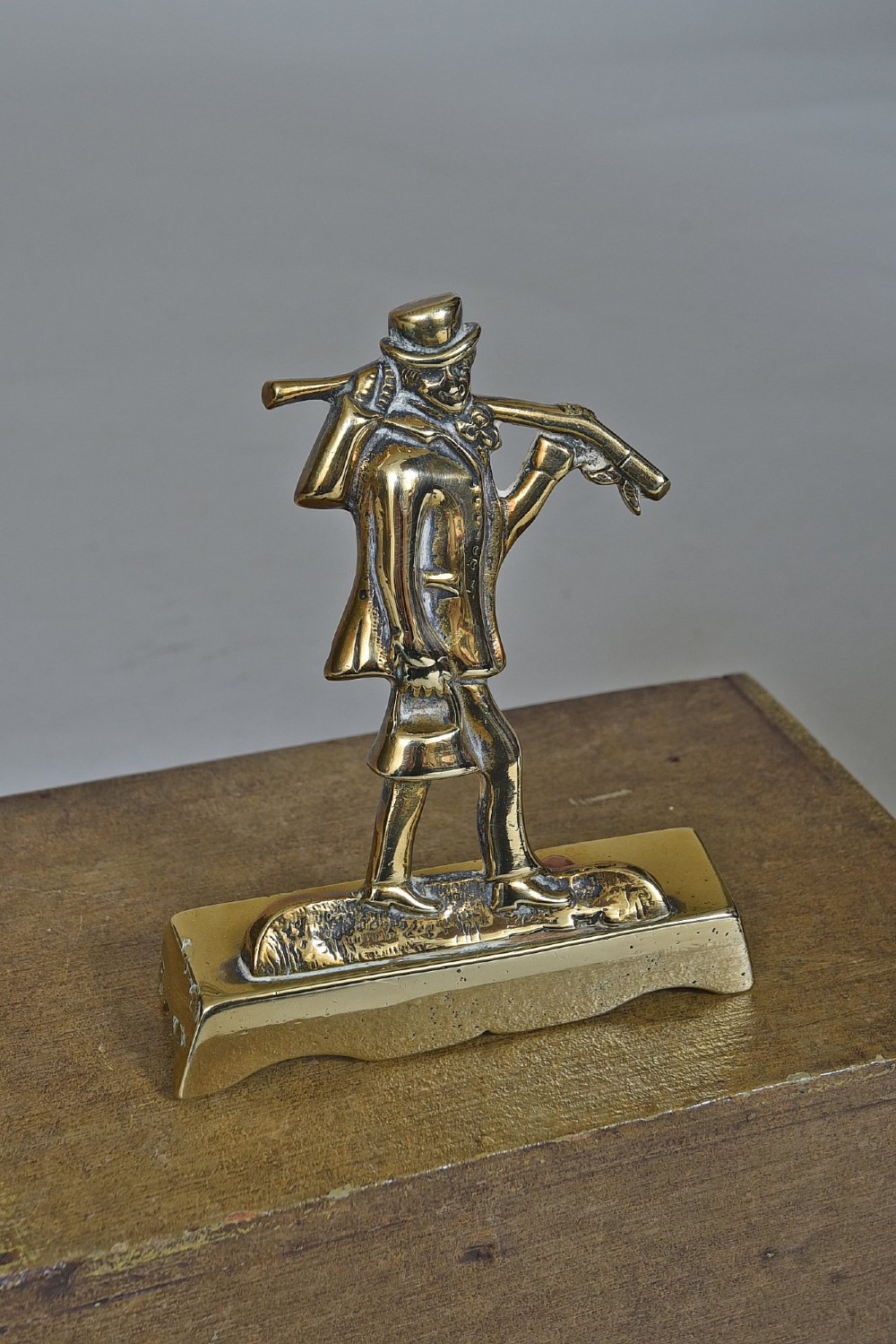 A pair of Victorian cast brass chimney ornaments depicting standing figures with rifles on rectangular plinths. View III