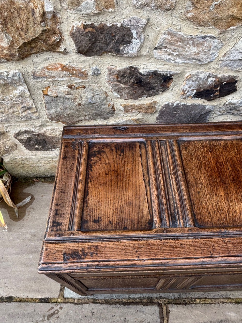 A 17th-century oak coffer featuring a hinged lid, panelled front, and geometric marquetry inlay. View III