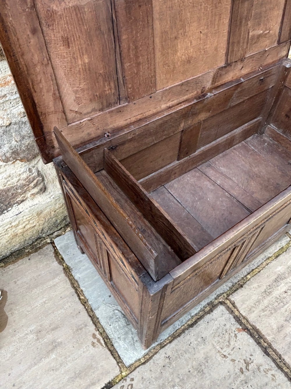 A 17th-century oak coffer featuring a hinged lid, panelled front, and geometric marquetry inlay. View IX