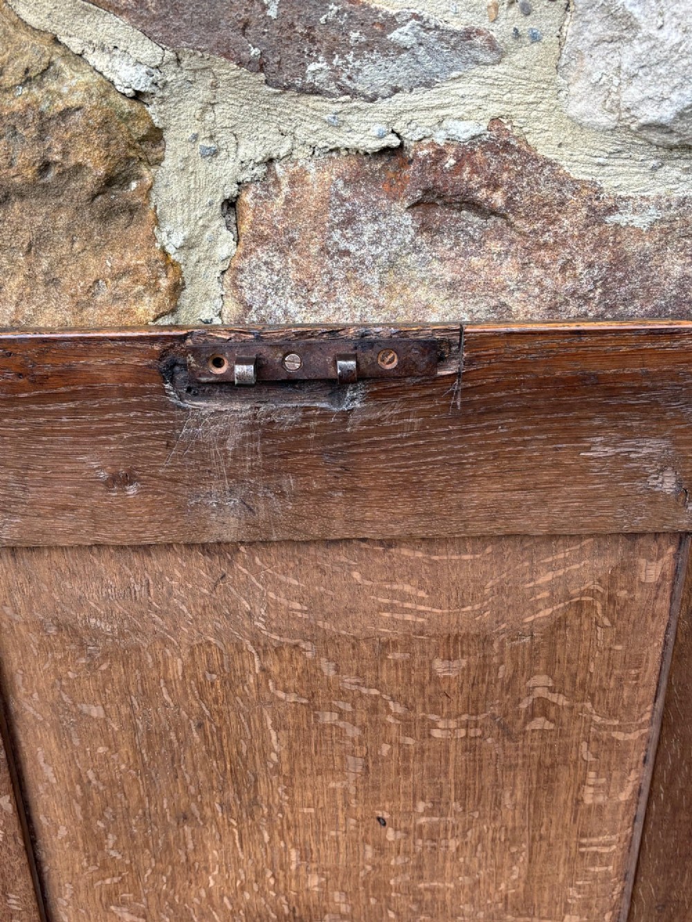 A 17th-century oak coffer featuring a hinged lid, panelled front, and geometric marquetry inlay. View X