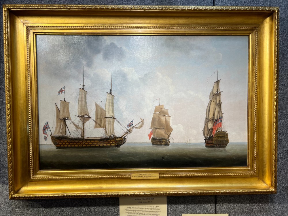 A framed 19th-century marine oil painting depicting three British Royal Navy sailing ships at sea set within an ornate giltwood frame.